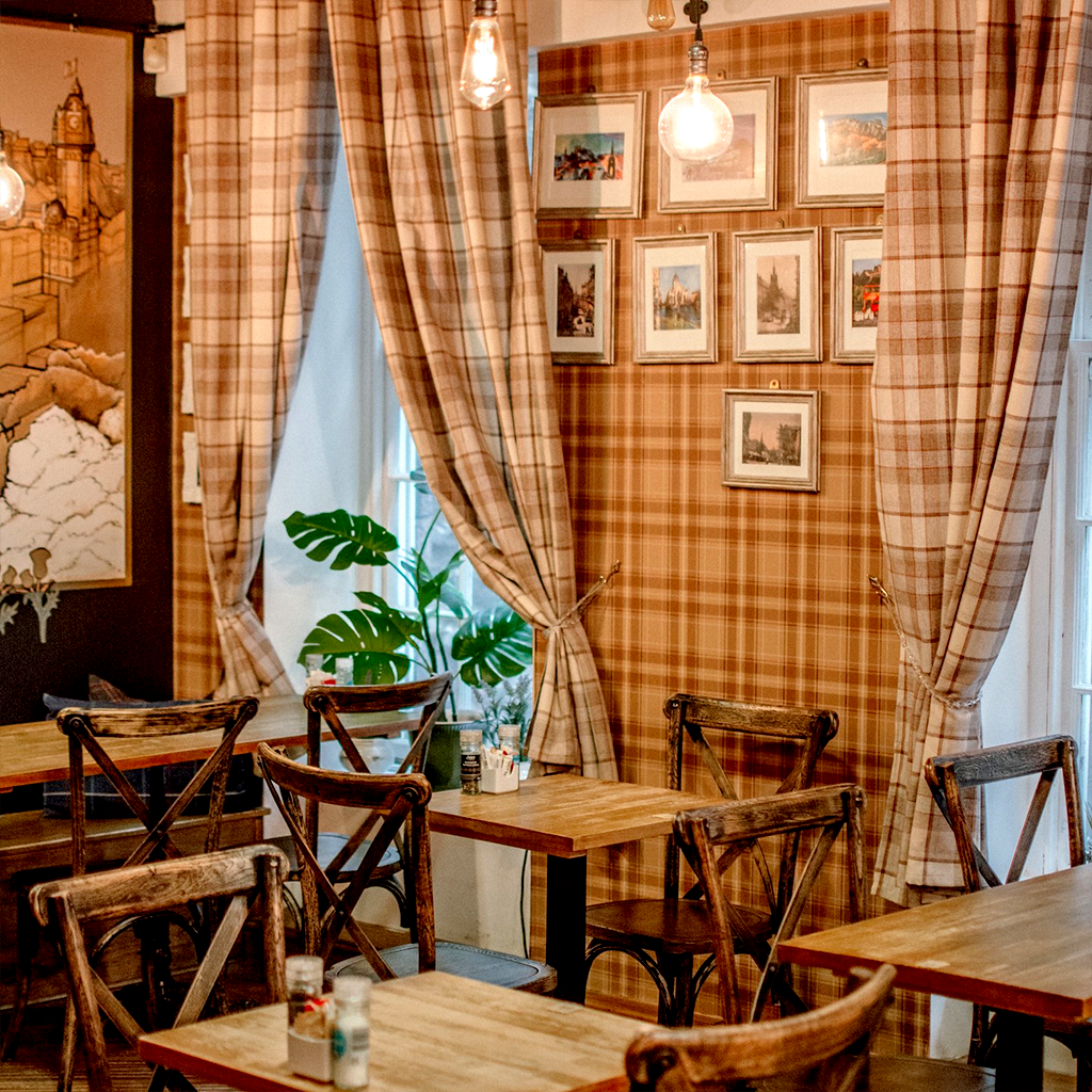 The counter and espresso machine inside Cafe Edinburgh at dusk